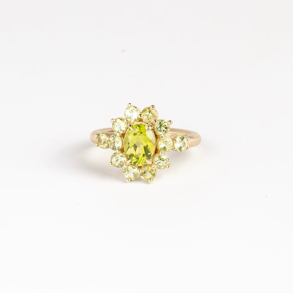 Peridot Chroma Flower ring by Elizabeth Street Jewelry is a one of a kind, bezel set and oval peridot with halo on a narrow band in 14k gold. Handmade in Los Angeles.