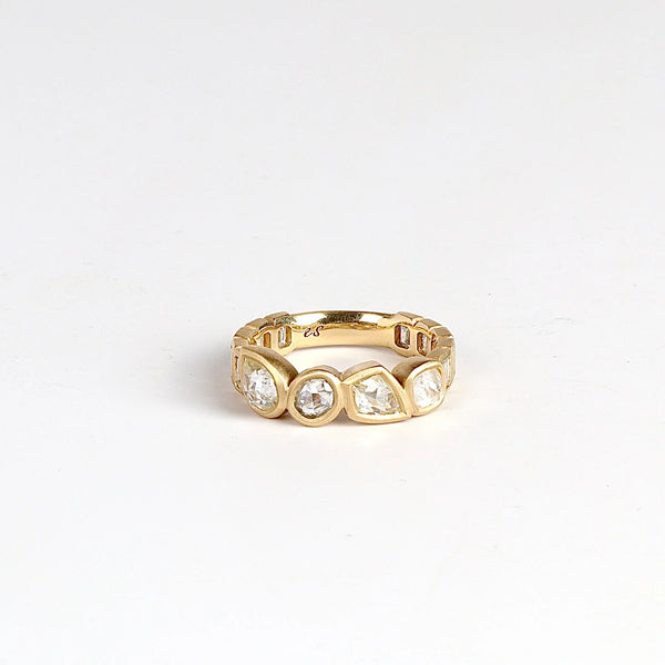 Diamond Medley Band by Elizabeth Street on white background. A Mixed cut and bezel set radiant cut diamonds 2.18TCW with white baguette accented shank on a 14k yellow gold band with satin finish. Handmade in Los Angeles.