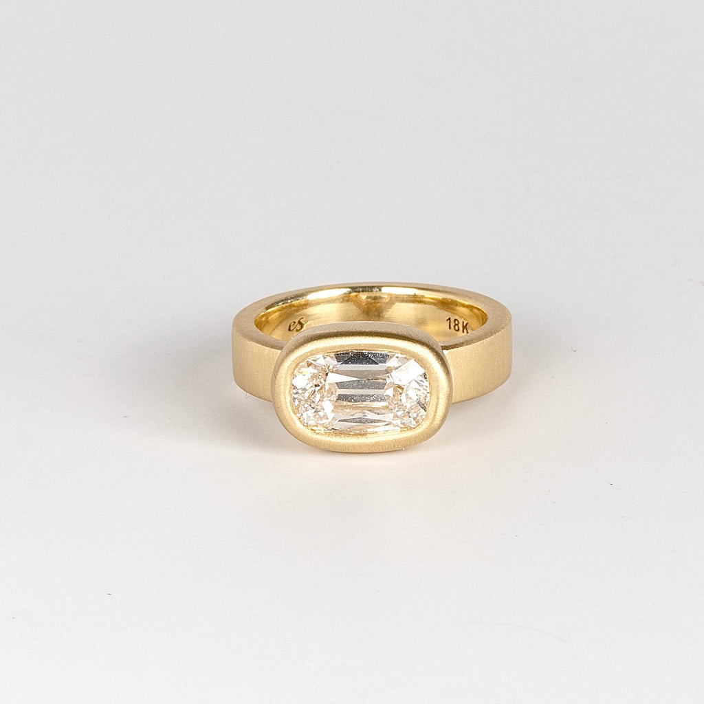 Jumbo Old Mine Solitaire Signet ring by Elizabeth Street is a bezel set cushion cut old mine lab grown white diamond solitaire on a wide and polished 18k gold band sized 6.5.