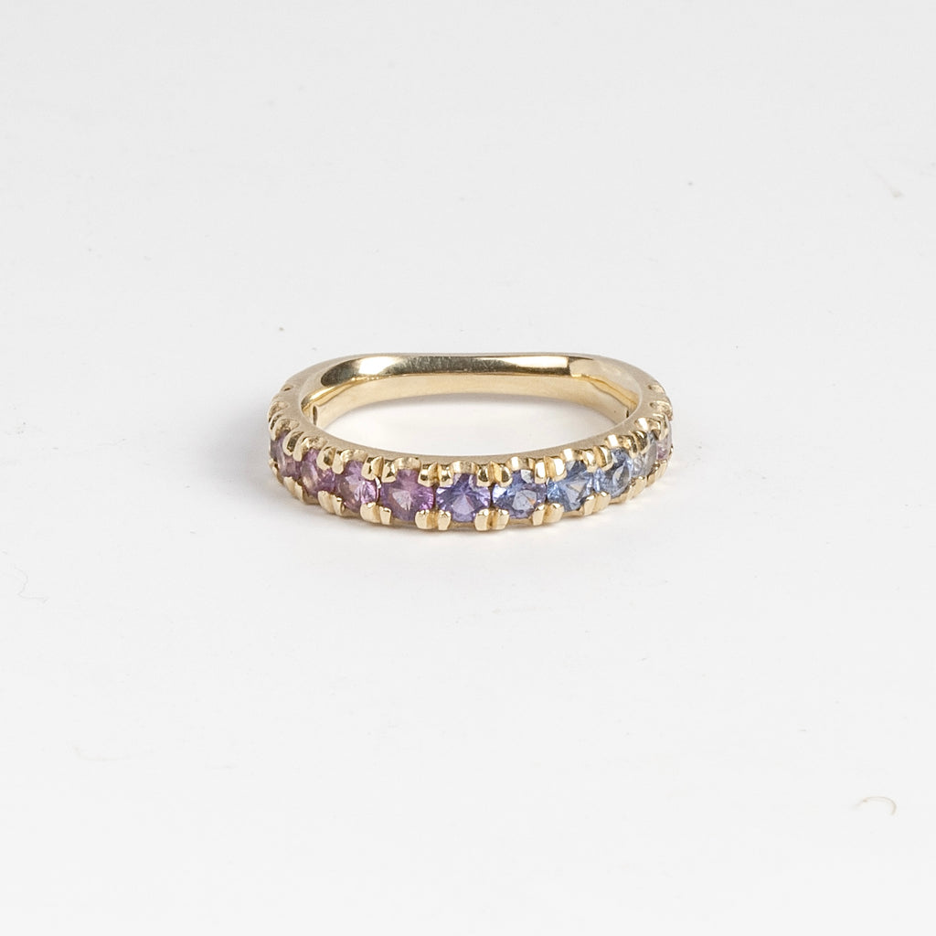 Purple Ombre Sapphire Euro Band by Elizabeth Street Jewelry is a gradient of mid purple to pink rose cut sapphires set into a&nbsp; euro eternity band in 14k gold. This band has a nearly flat back/underside for ultimate comfort and is perfect for stacking. Handmade in Los Angeles.