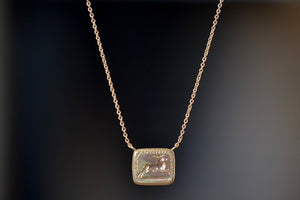 Pain Makes Me Fly Duo Motto Necklace by Makiko Wakita made  by stamping an 1800s carved seal with 'mottos' in French, Italian, Latin or English on to gold. A rectangular disc in gold with satin finish that will turn shiny over time features an image of a running stag/hart/deer pierced by an arrow with French words "La Douleur Cause Ma Fuite" (‘Pain Makes Me Fly’ or ‘Pain and Sorrows Cause Me To Flee’). This piece could signify a loss in love or life, but not in pride and spirit, and endure and move for