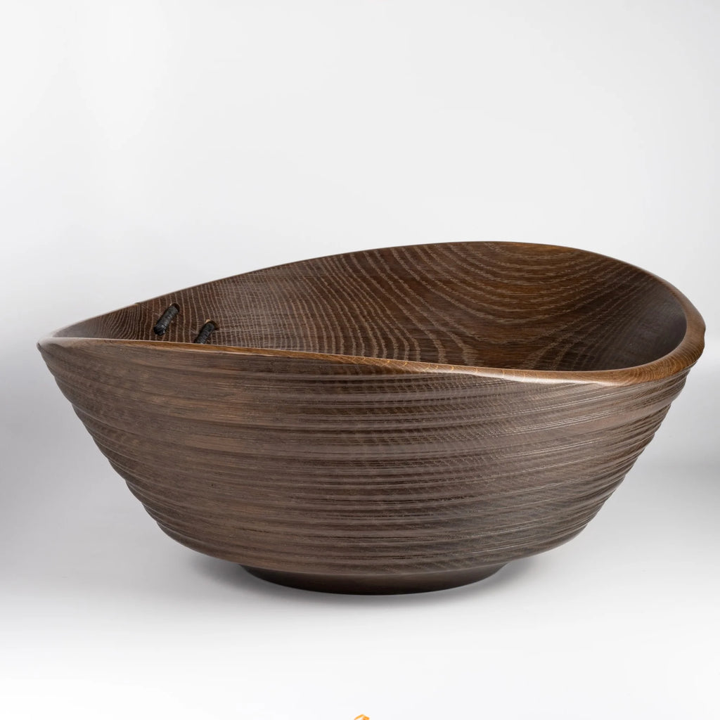 A big turned wood Circle Factory Bowl in Brown Oak With Ridges and Repair Detail by George Petersen on white background.