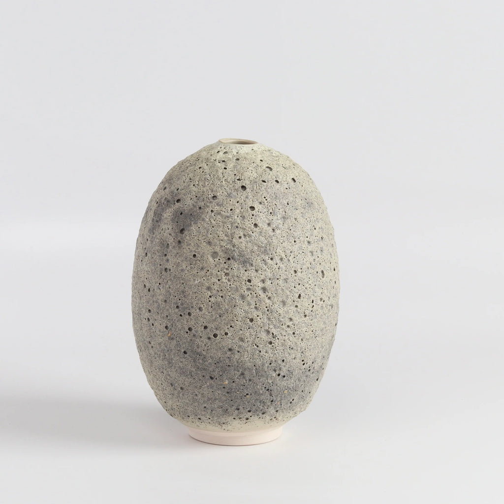 Heather Rosenman oval ceramic vase in gray to white volcanic glaze on white background.