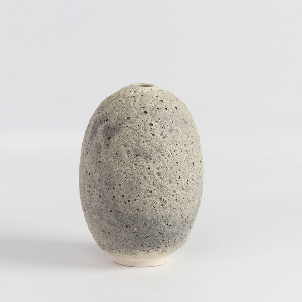 Heather Rosenman oval ceramic vase in gray to white volcanic glaze on white background.