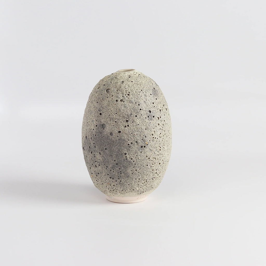 Heather Rosenman oval ceramic vase in gray to white volcanic glaze on white background.