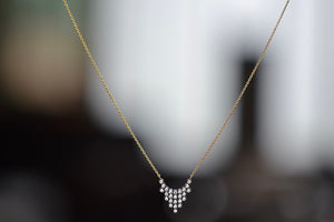 Charnières Pétale Pendant Necklace by Yannis Sergakis is twenty-Five (25) rhodium plated round cut diamonds that form a triangular pendant on an 18k gold chain. Utilizing a traditional Greek method, Yannis Sergakis created the Pétale collection which is made out of gold, rhodium plated round diamonds and architectural designs meant for everyday use.  Handmade in Athens, Greece.