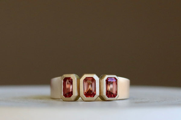 Triple Sapphire Band by Elizabeth Street Jewelry is made out of three rose sappires bezel set into a simple satin brushed and tapered band in 14k yellow gold. Handmade in Los Angeles.