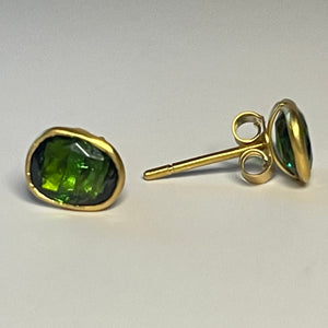 Green Tourmaline stud earrings on white.