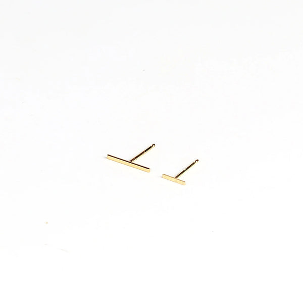 Kathleen Whitaker Staple Earring Bar stud in large and regular or small  in 14k yellow gold on white background.