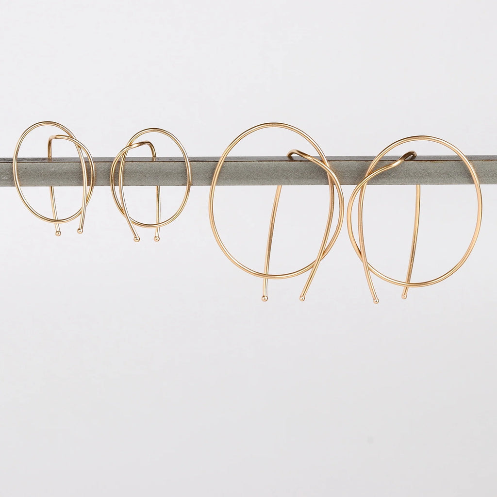 Kathleen Whitaker Rope earrings in small and medium. Gold wire is bent in a take on a classic hoop.