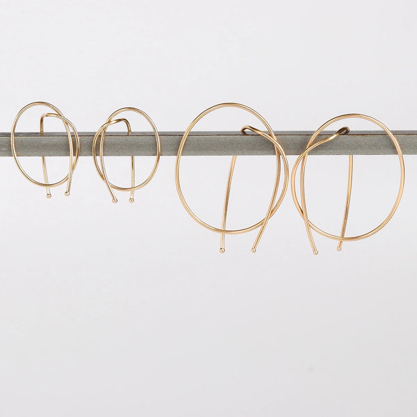 Kathleen Whitaker Rope earrings in small and medium. Gold wire is bent in a take on a classic hoop.