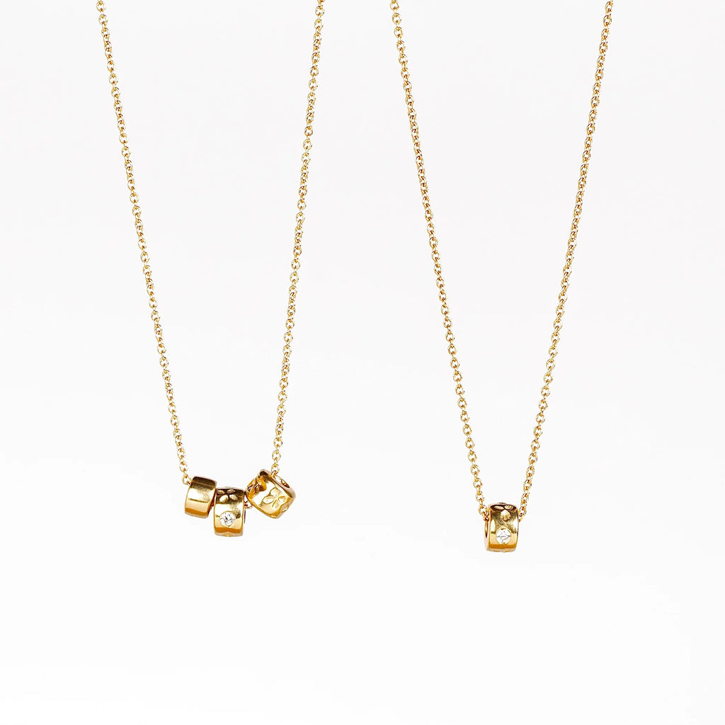 Three and one bead necklaces in 14k gold with Canadian diamonds by Kaylin Hertel on white background.