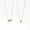 Three and one bead necklaces in 14k gold with Canadian diamonds by Kaylin Hertel on white background.