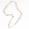 Short 14k gold paperclip chain necklace with two short, one long flat clips in 15 inches by Kaylin Hertel on white background.