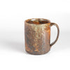 The LO mug is a wood fired ceramic mug by Lindsey Oesterritter. Wood ash in the kiln results in highly varying surfaces so each one unique and one of a kind. This one is number 2.