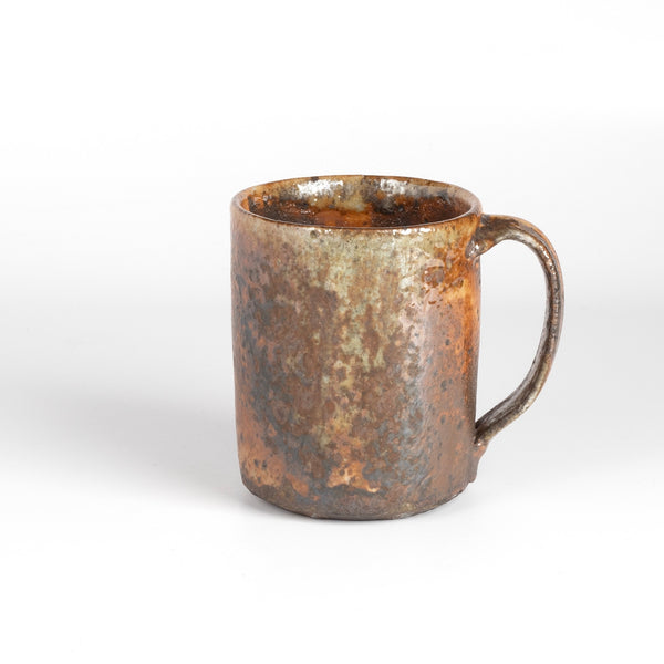 The LO mug is a wood fired ceramic mug by Lindsey Oesterritter. Wood ash in the kiln results in highly varying surfaces so each one unique and one of a kind. This one is number 2.