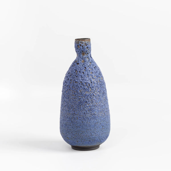 Tall Blue Bottle vase in volcanic glaze by Heather Rosenman on white background.