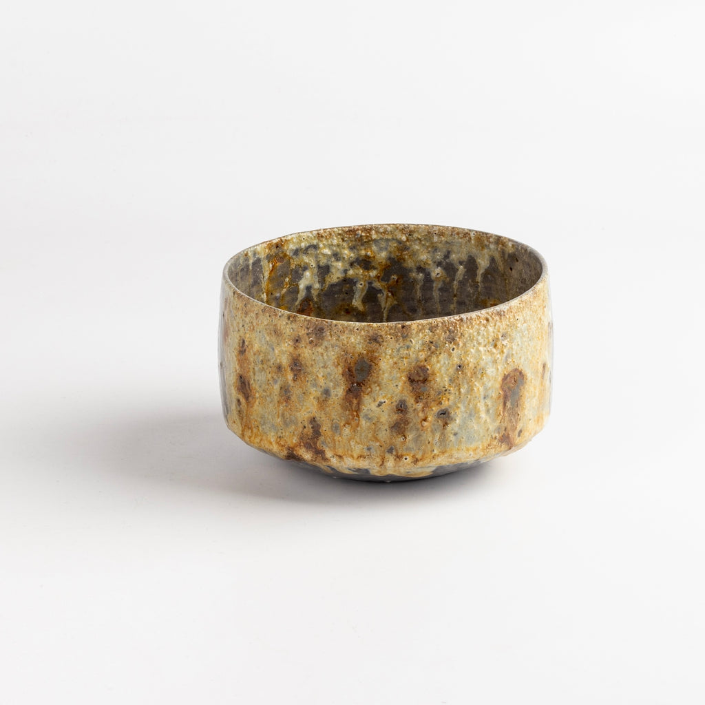 Wood Fired Tea Bowl With Spots is a one of a kind wood fired and reduction cooled tea bowl in bluish grays and browns with a textured side of brownish beige and dark spots. Hand thrown porcelain by Lilith Rockett, who works out of Portland, Oregon.