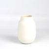 Lilith Rockett Vase with Neck "A" is Reminiscent of an eggshell, this vase is wheel thrown porcelain with gloss glaze on the interior and an unglazed exterior. It has been sanded smooth and it is very stable despite its rounded bottom. 