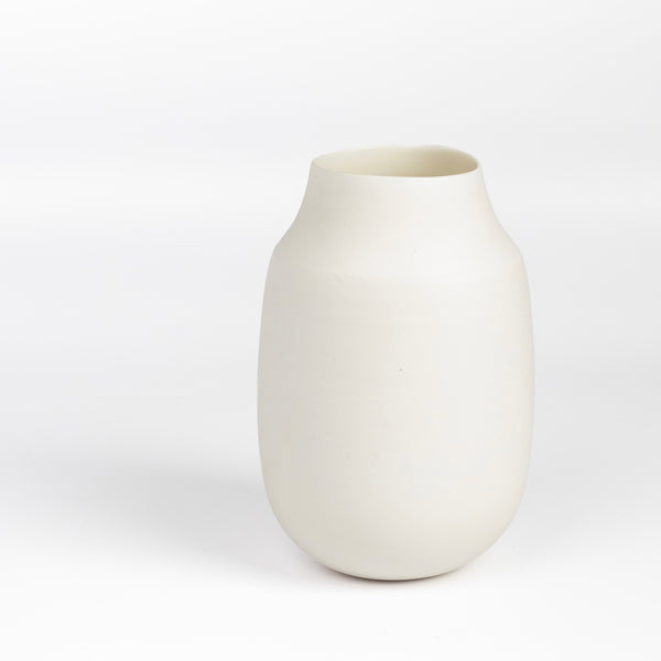 Lilith Rockett Vase with Neck "A" is Reminiscent of an eggshell, this vase is wheel thrown porcelain with gloss glaze on the interior and an unglazed exterior. It has been sanded smooth and it is very stable despite its rounded bottom. 