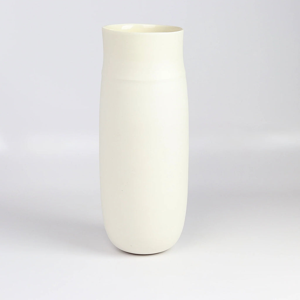 Lilith Rockett Tall vase is reminiscent of an eggshell. It is hand thrown porcelain with gloss glaze on the interior and an unglazed exterior that has been sanded smooth and it is very stable despite its rounded bottom. Handmade in Portland, Oregon. 