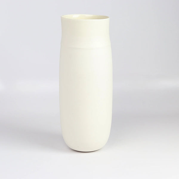 Lilith Rockett Tall vase is reminiscent of an eggshell. It is hand thrown porcelain with gloss glaze on the interior and an unglazed exterior that has been sanded smooth and it is very stable despite its rounded bottom. Handmade in Portland, Oregon. 