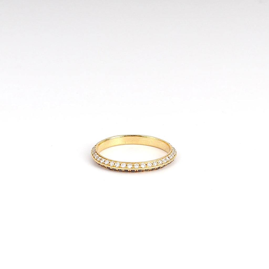 Lizzie Mandler The Othello Knife Edge Band ring in 18k yellow gold is a double eternity band  with black diamonds inone side and white on the other, shown on white background