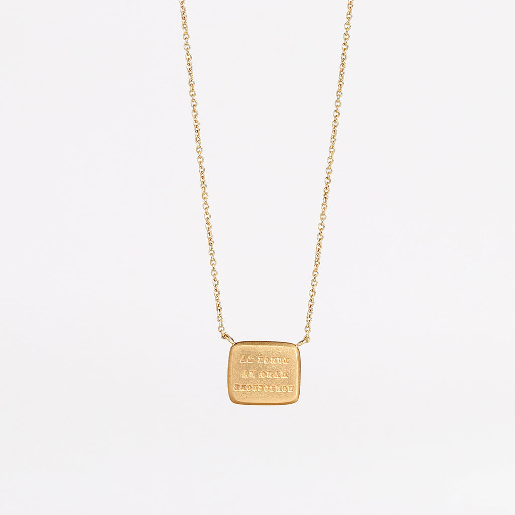 Back of Unconditional Motto Necklace on white background.