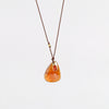 Hessonite and Sapphire Pendant Necklace designed by Margaret Solow is a A faceted Hessonite stone slice accompanied by a smaller orange and faceted sapphire slice of which the smaller is set in 18k gold with with a gold bead on the string makes this one of a kind organic pendant necklace.