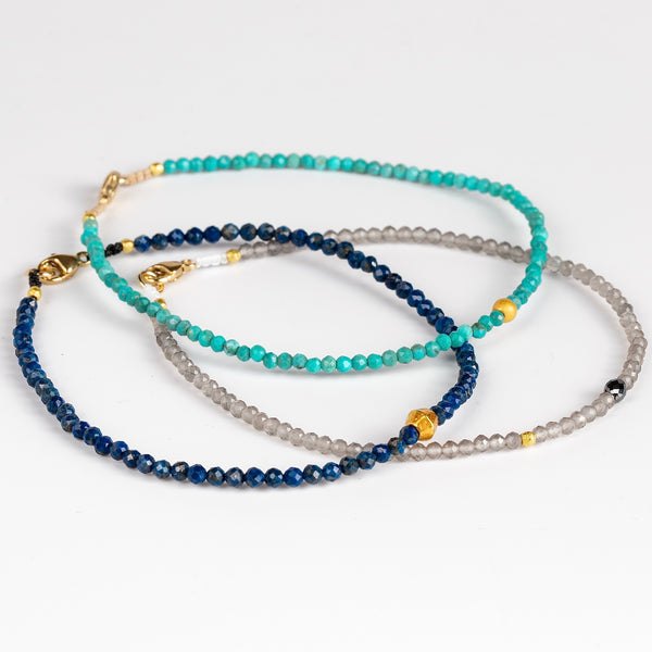 Stone and 18k Bead Bracelets by Margaret Solow. These are thin bracelets made of tiny stones on nylon thread with an 18k gold bead accent, and a gold clasp closure. One of a kind. 