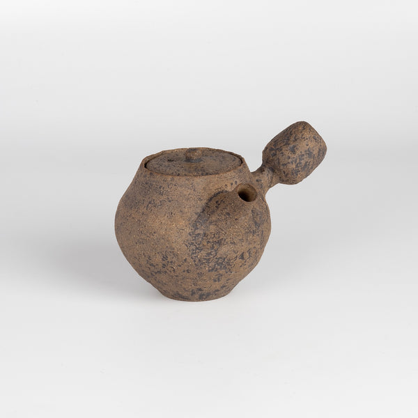 Kyusu Ceramic teapot in brown from Muzuri Ware is a composed ceramic teapot, utilizing mostly black stained London clay, textured and inlayed with costal wild Cornish clay. or inlayed with black iron oxide. Wheel thrown and assembled with interior holes to work with a variety of tea leaves by Kyriacos Mouzouris in London UK.