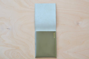 Inside of Olive Alice Park simple flap wallet with yellow stitching.