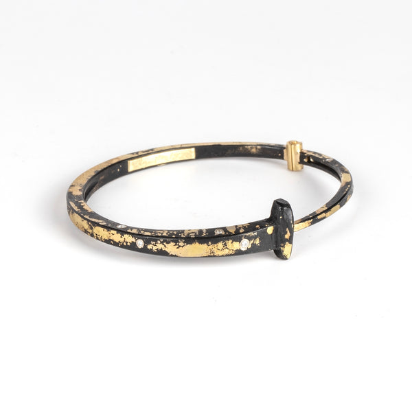 Nine Stone Dust 9 Nail Bracelet by Pat Flynn is a forged  nail bracelet with mid-coverage in 22k fused gold with nine scattered accent diamonds and completed with an 18k gold hinge and ball catch 