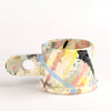 Other side of EXP Standard Splatter Mug in Pastels and Black.