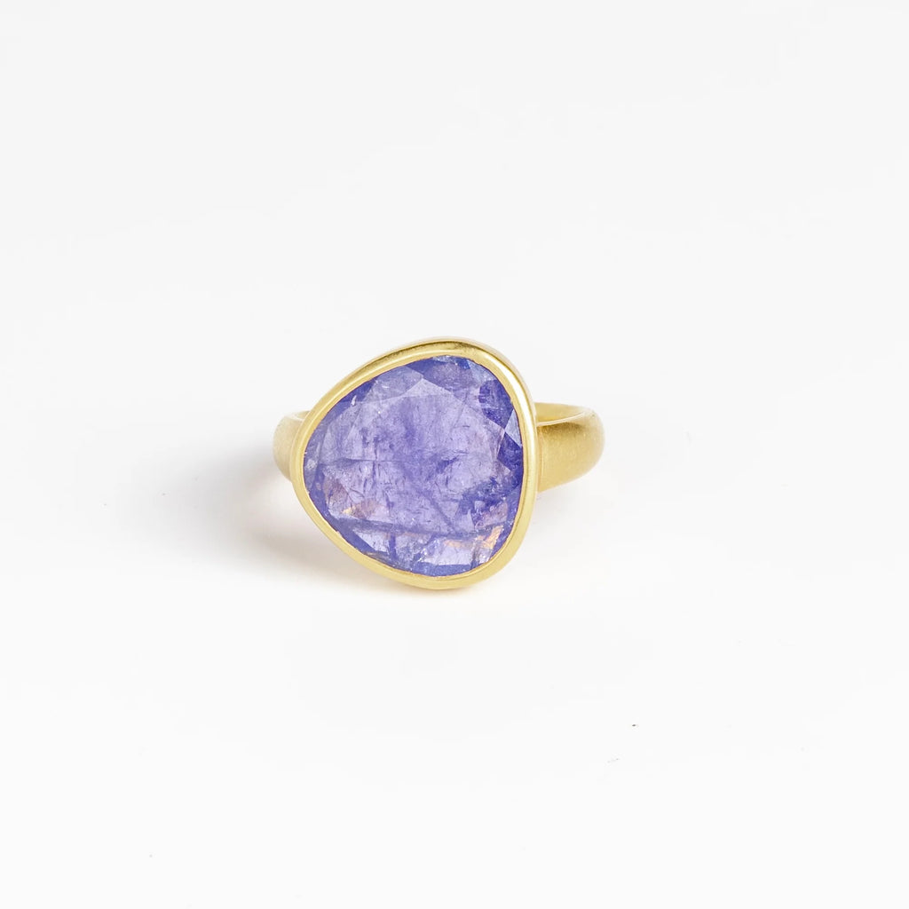 The Tanzanite Greek Ring by Pippa Small Jewellery is an organically shaped, and hand cut, bright purple, faceted and translucent tanzanite stone set in 18k yellow gold. Size 6 in stock.