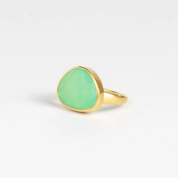 The Chrysoprase Greek Ring by Pippa Small Jewellery on white background  is an organically shaped, and hand cut, bright green, faceted and translucent chrysoprase set in 18k yellow gold. Size 6.5 in stock.