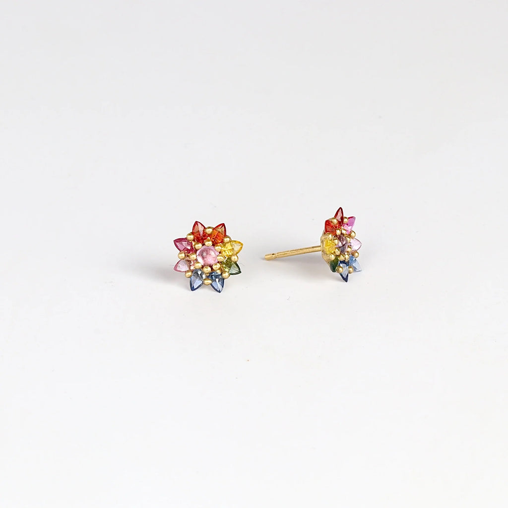 Side view of Rainbow Daisy studs (pair) by Polly Wales on white background.