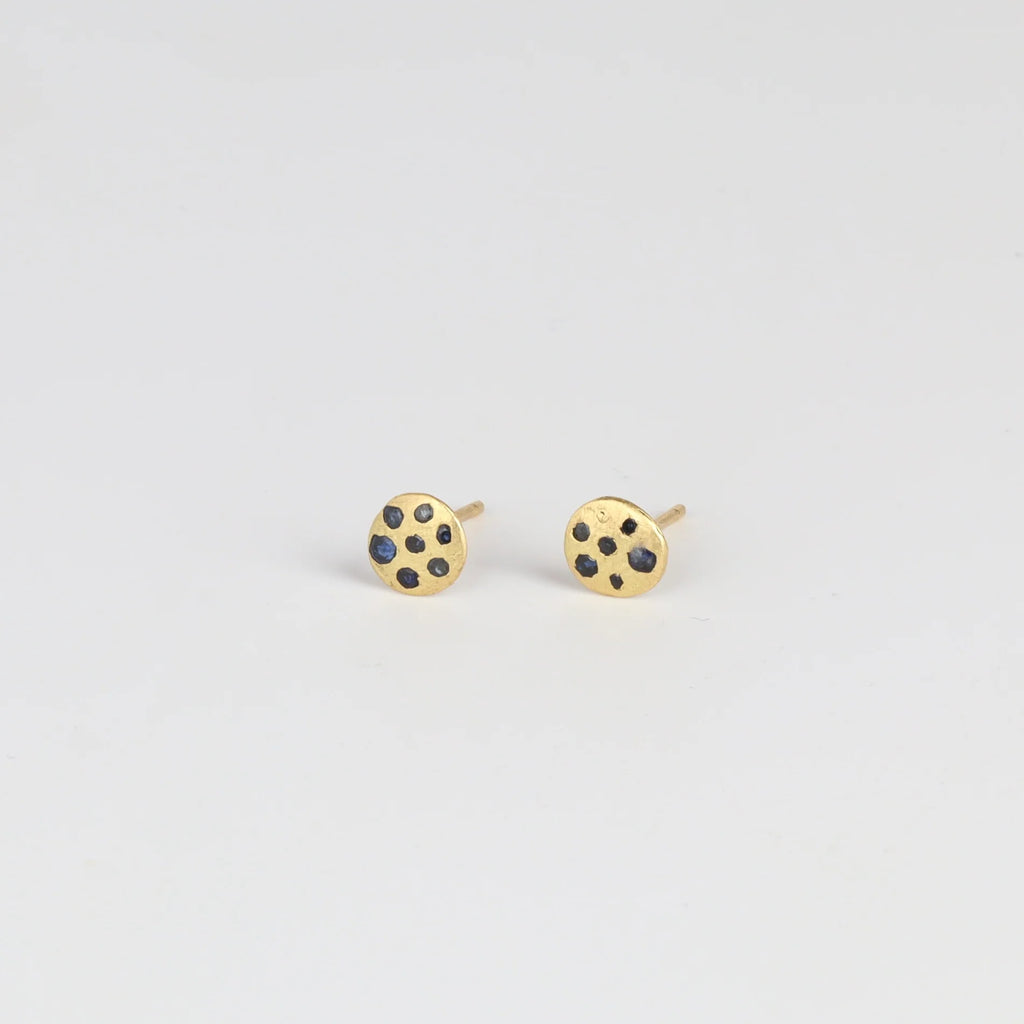Side view of Polly Wales XS XSmall extra small Confetti Celeste Disc Stud Earrings in mid blue to navy Sapphires.