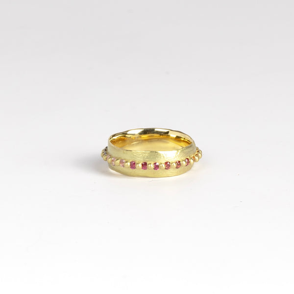 Nina ring in Rainbow by Polly Wales is a wide and organically shaped pinch style band in 18k recycled yellow gold is encrusted with all round Rainbow Sapphires in pink, yellow, orange, green and blue around the circumference. Recycled gold. Cast in Place. Cast not set. Handmade in Los Angeles.