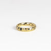 Black and White Confetti Band by Polly Wales is a narrow 18k yellow gold band with speckled black and white sapphires around the circumference for a beautiful confetti-like appearance. Recycled gold. Cast not set. Handcrafted in Los Angeles. Sie 6.5 n stock