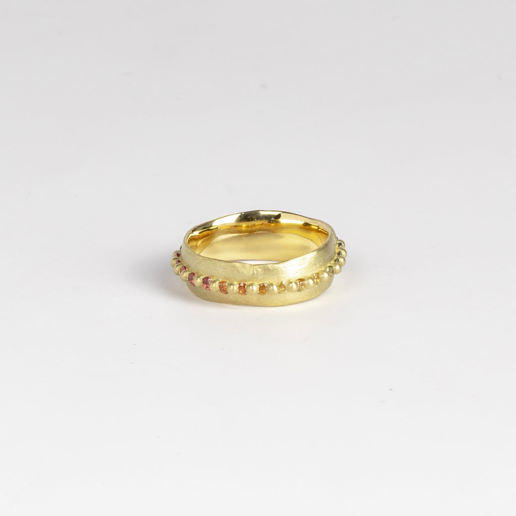 Nina ring in Rainbow by Polly Wales, showing pink, orange and yellow round sapphires.