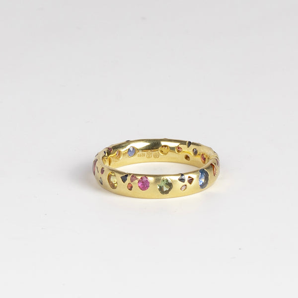 Rainbow Confetti Ring Band by Polly Wales is a narrow 18k gold band with speckled mixed sapphires around the circumference for a beautiful confetti-like appearance. Recycled gold. Cast not set. Handcrafted in Los Angeles.
