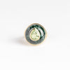 Petite Lollipop Ring in Tourmaline Pear and Green Jade by Retrouvai is a one of a kind ring featuring a chunky and rounded stone face with a translucent center stone set on atiered edge and tapered band. This one features hand carved jade with a pear cut mint green tourmaline in the center.