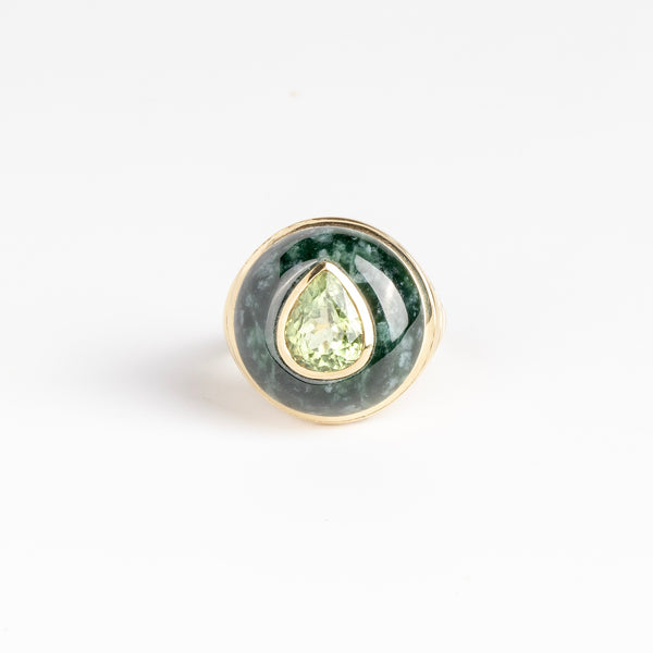 Petite Lollipop Ring in Tourmaline Pear and Green Jade by Retrouvai is a one of a kind ring featuring a chunky and rounded stone face with a translucent center stone set on atiered edge and tapered band. This one features hand carved jade with a pear cut mint green tourmaline in the center.