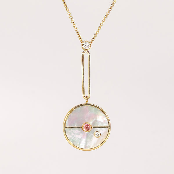 Compass Pendant in White Mother of Pearl and Pink Spinel is a unique modern take on an heirloom pendant. Stone inlay is accented with a center gem stone and white diamond. The compass hangs from an elongated paperclip link accented with a second white diamond. Handcrafted in Los Angeles.