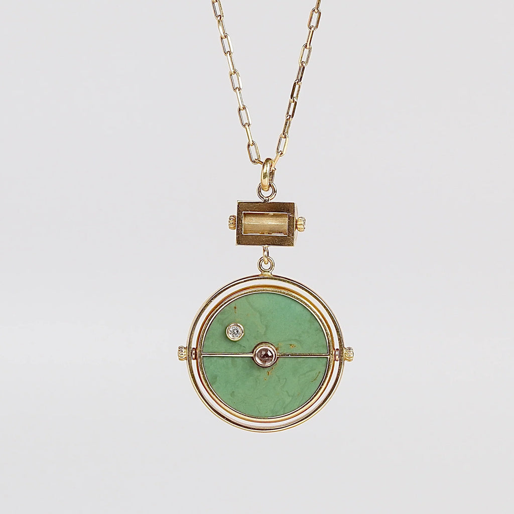Back side of  Grandfather Compass Pendant in Green Turquoise and Tanzanite by Retrouvai on white background.