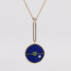 Close up of Compass Pendant Necklace in Lapis and Emerald by Retrouvai on white background. Made in LA.