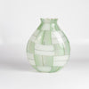 A large basketweave vase designed by Robin Mix in Tunbridge Vermont. Hand blown vase in green with windows of detail, using Italian techniques available at OK.