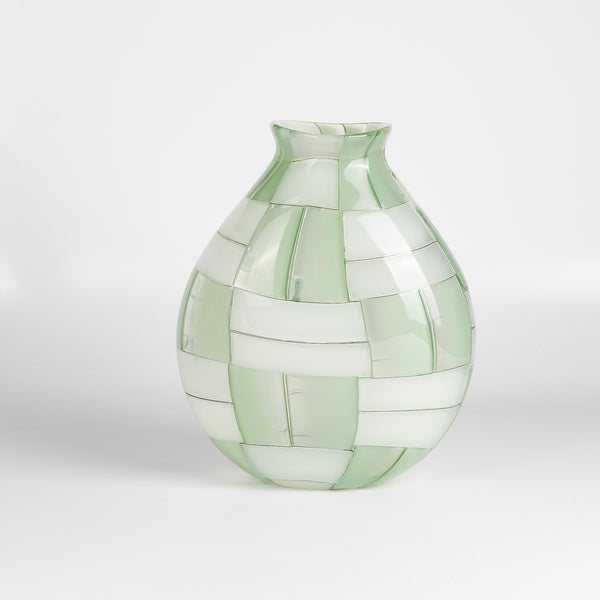 A large basketweave vase designed by Robin Mix in Tunbridge Vermont. Hand blown vase in green with windows of detail, using Italian techniques available at OK.