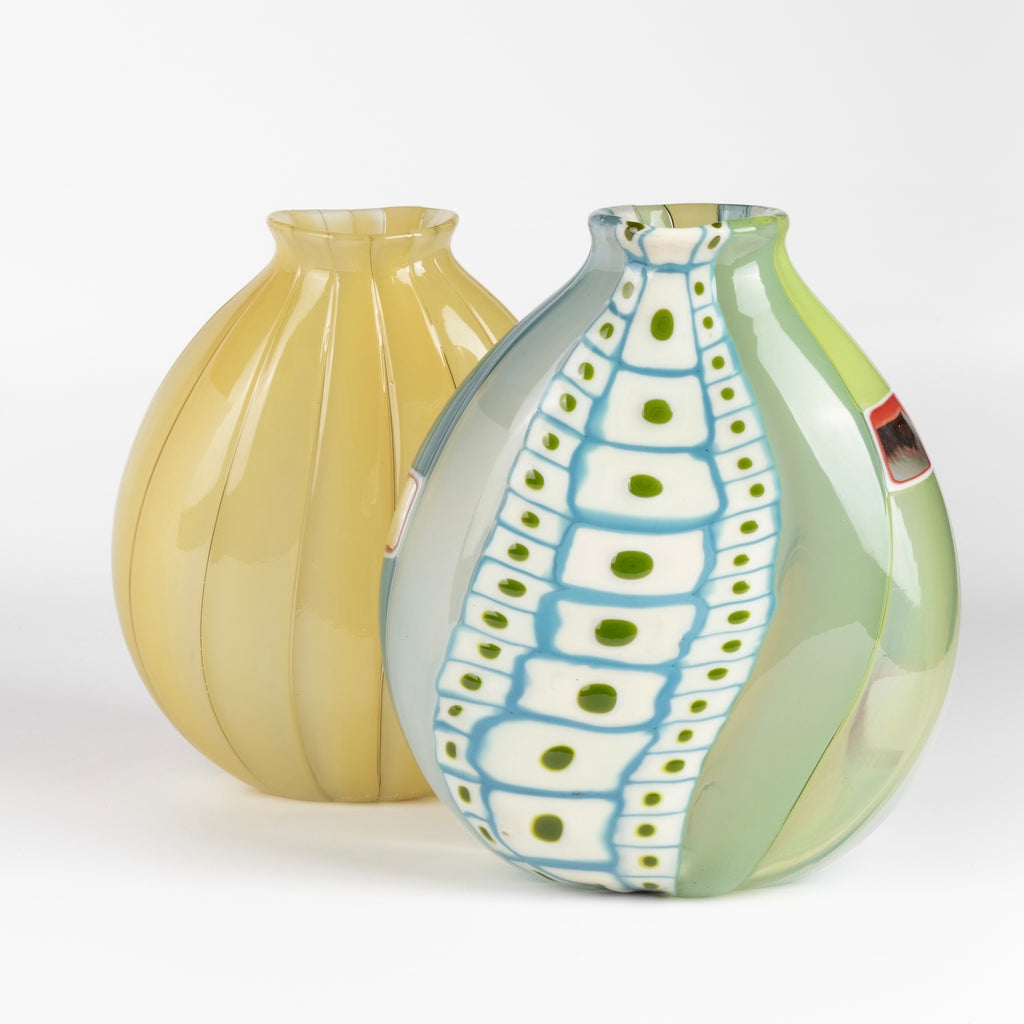 Small Flat Cane Vase with Murrini and windows in front of a flat tobacco cane "onion skin" vase. Both are mouth or hand blown by Robin Mix for Studio Glass in Tunebridge, Vermont.